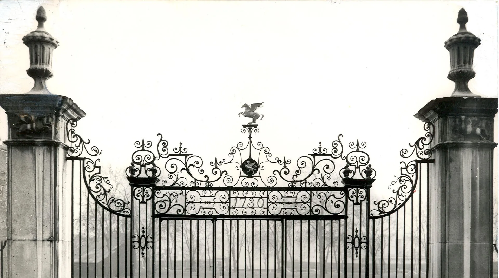 Ornate iron gates representing access to elite executive search